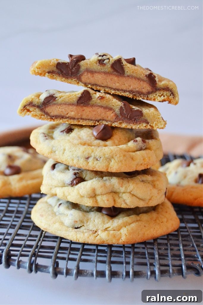 Peanut Butter Cup Stuffed Cookies: Gooey Chocolate Surprise 4 a stack of cookies with a split open peanut butter stuffed cookie on top