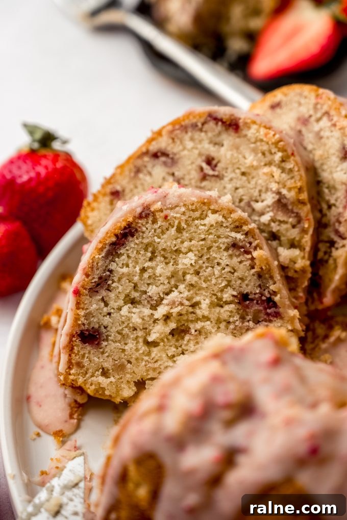Strawberry Jello Poke Cake Recipe — Moist, Creamy Dessert 18 Slices of strawberry Bundt cake on a plate.