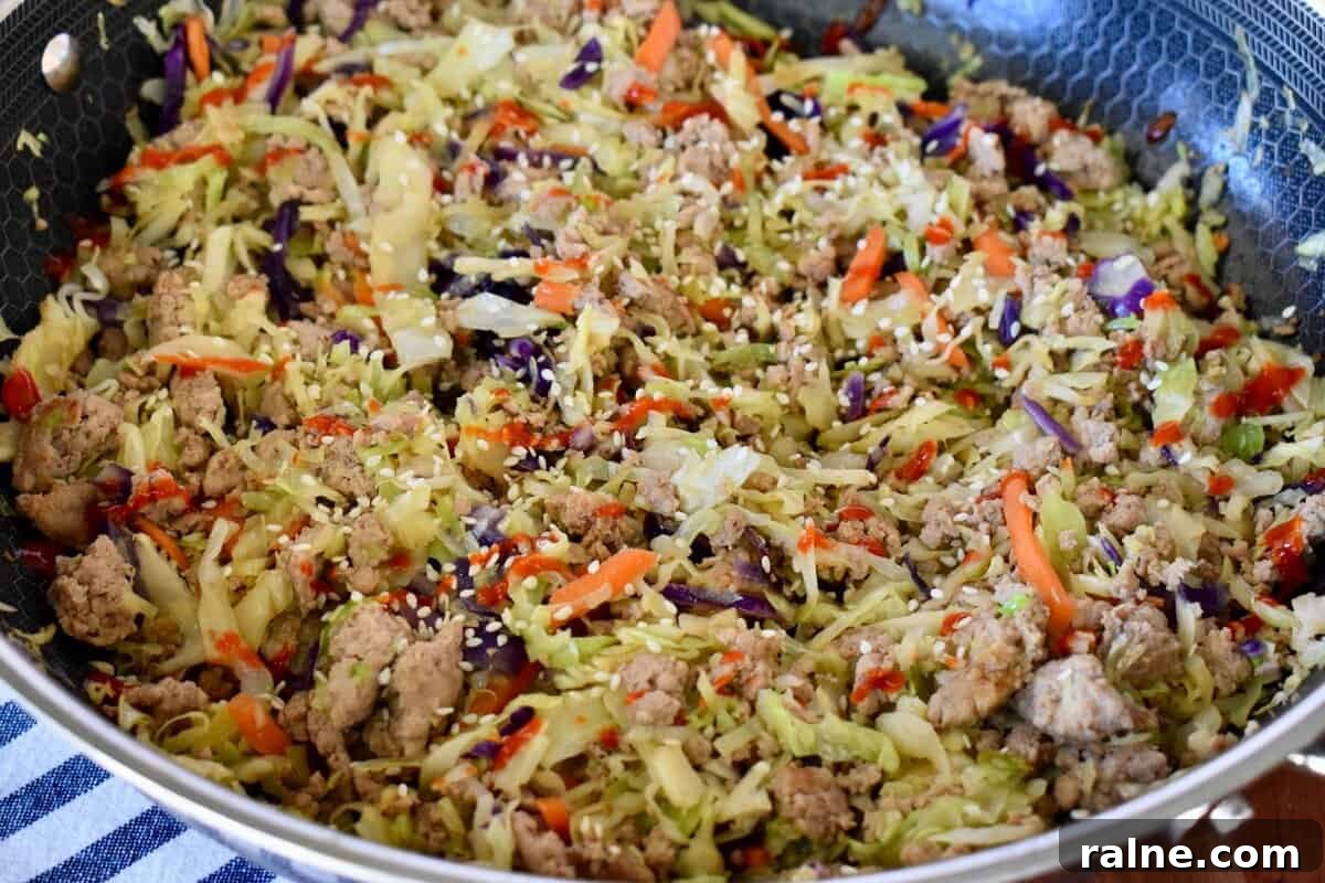 Egg Roll in a Bowl with Ground Turkey and Sriracha sauce drizzle on top. 