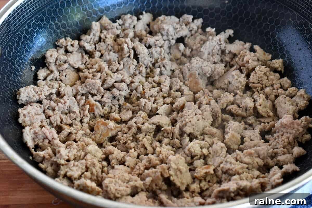 Ground turkey cooked in a large skillet. 