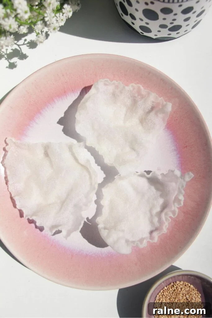 Spicy Tuna Crispy Rice Paper Cups Recipe for Impressing Guests 6 Three crispy rice paper cups on a pink plate.