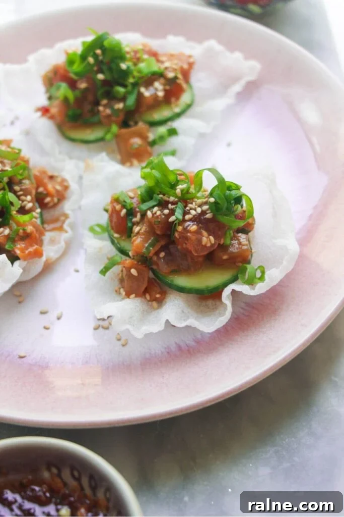 Spicy Tuna Crispy Rice Paper Cups Recipe for Impressing Guests 8 Close up of tuna rice paper cup on a pink plate.