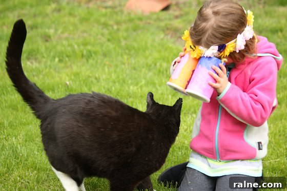 DIY Pringles Can Binoculars: Fun Craft Project for Preschoolers 12 kid looking at cat through toy binoculars
