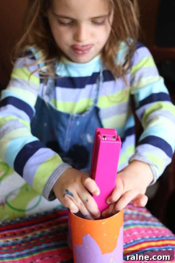 DIY Pringles Can Binoculars: Fun Craft Project for Preschoolers 4 child stapling pringles cans together