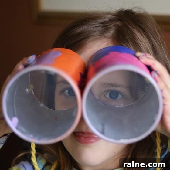 DIY Pringles Can Binoculars: Fun Craft Project for Preschoolers 7 child looking through binoculars she made with pringles cans