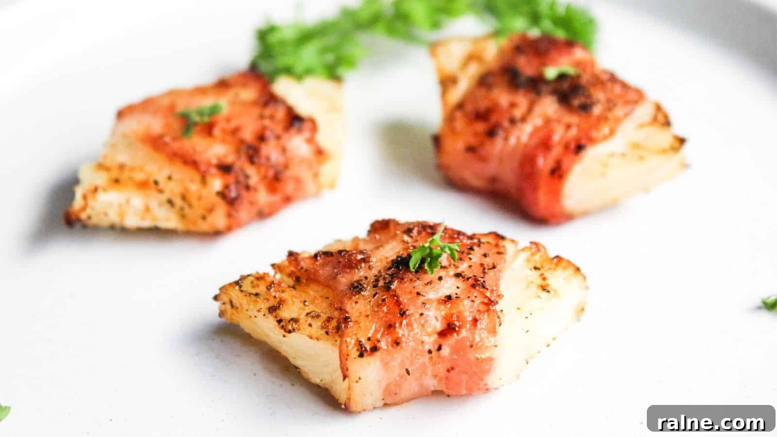 9 Simple Appetizers You Can Make With Just a Few Ingredients 5 Bacon wrapped pineapple on a white plate.