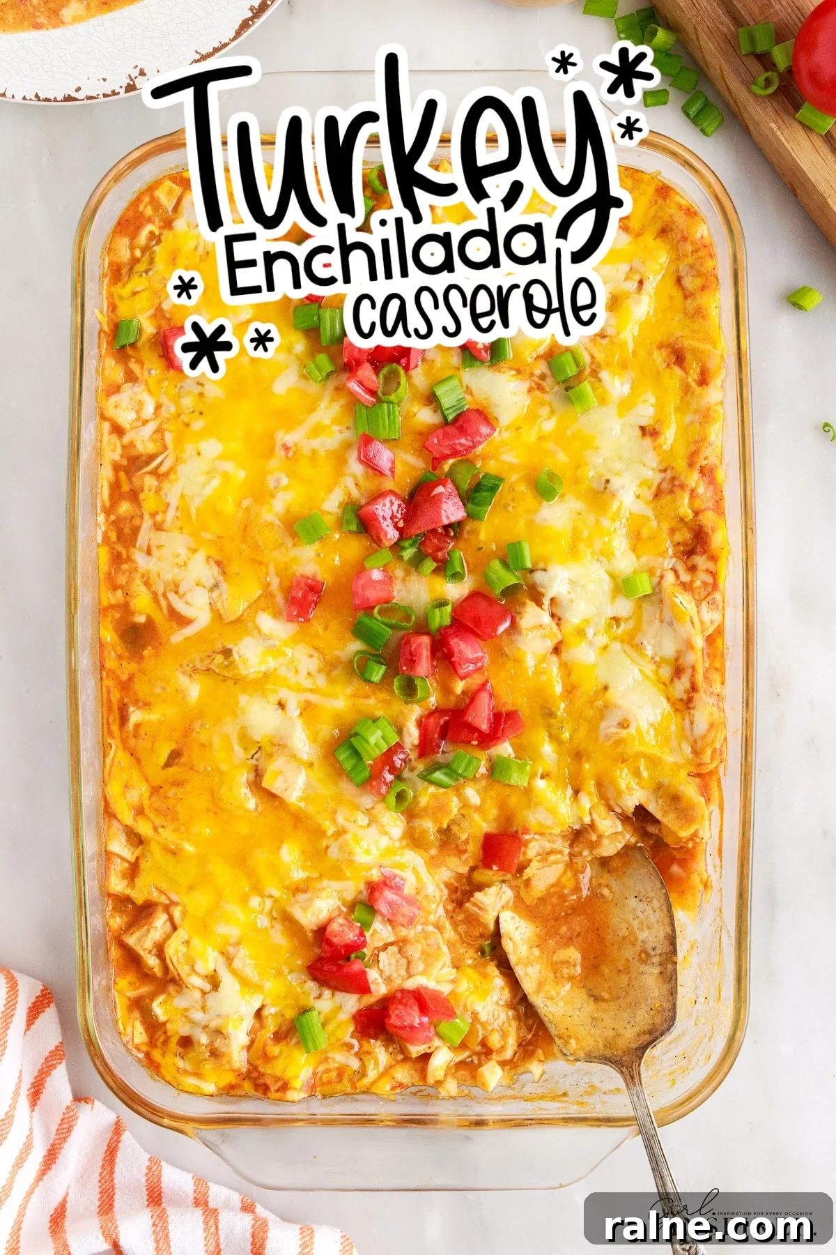Turkey enchilada casserole with a spoon inserted and some missing, with title overlay.