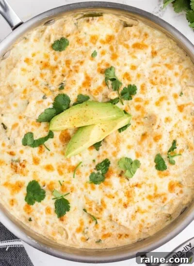 Skillet filled with White Chicken Enchilada Casserole.