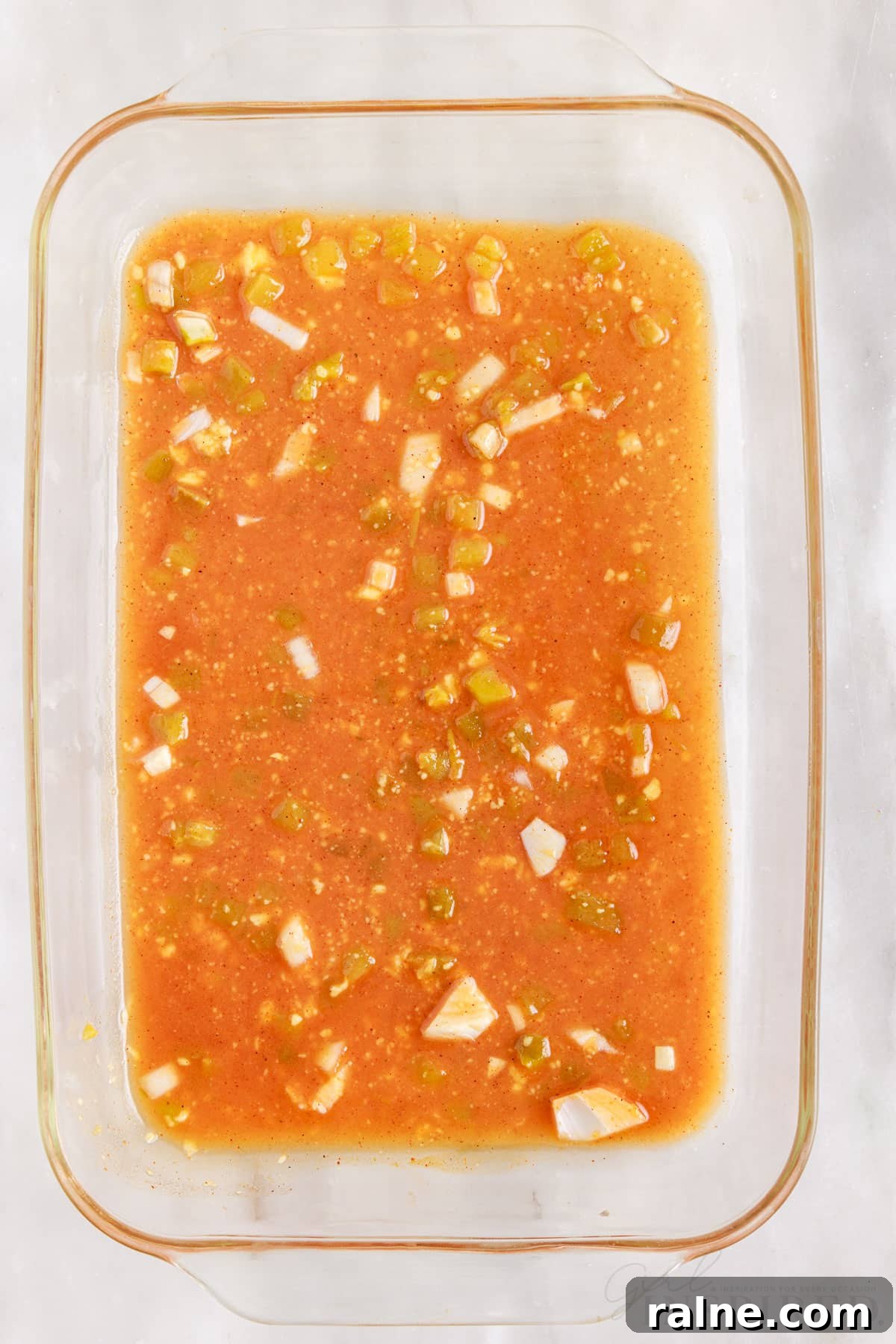 a little sauce mixture covering the bottom of a 9x13