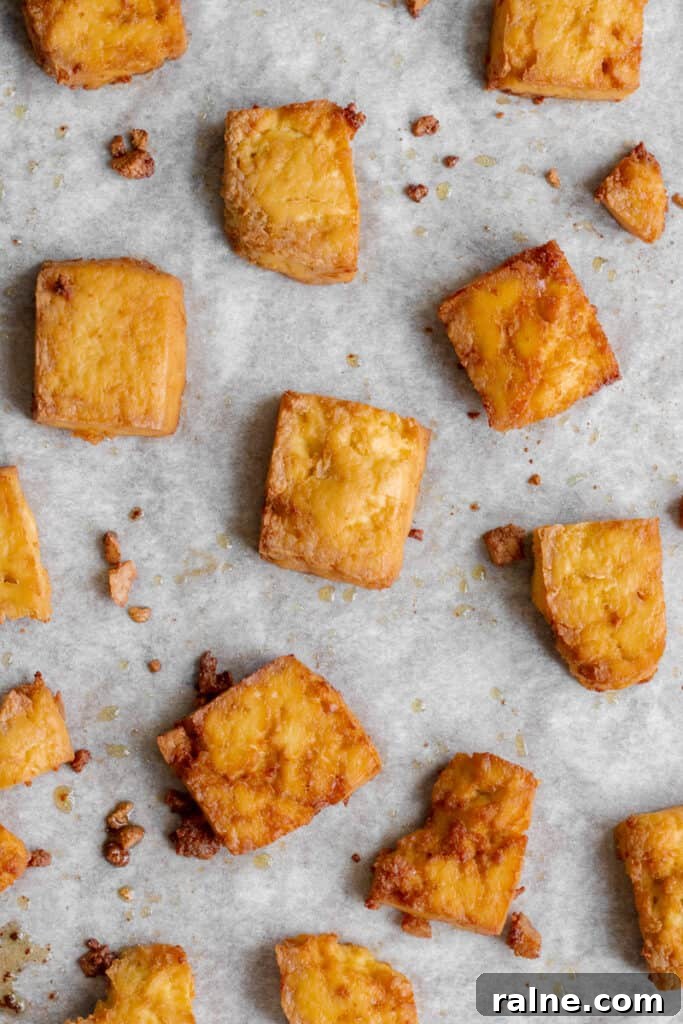 Crispy baked tofu on baking tray.