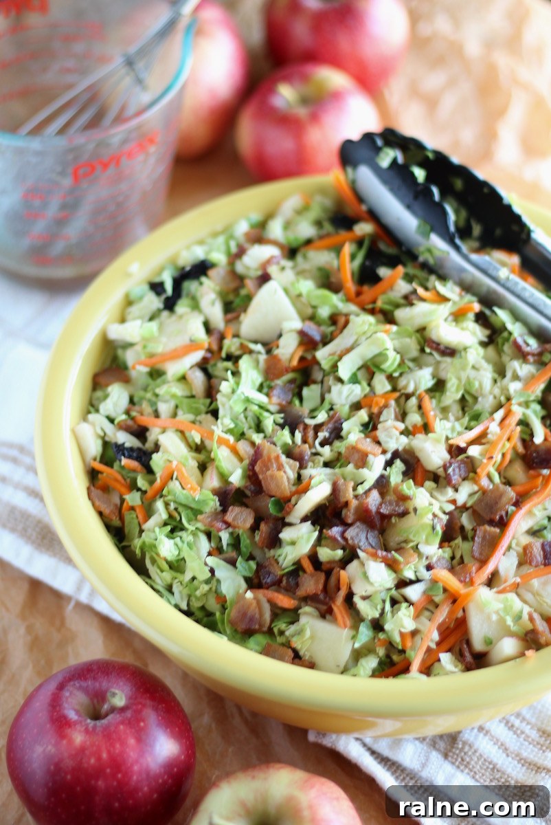 Apple Bacon Brussels Sprouts Salad - a flavor-packed Fall salad loaded with bacon, apples, brussels sprouts, carrots, dried cherries, and an apple cider bacon vinaigrette!