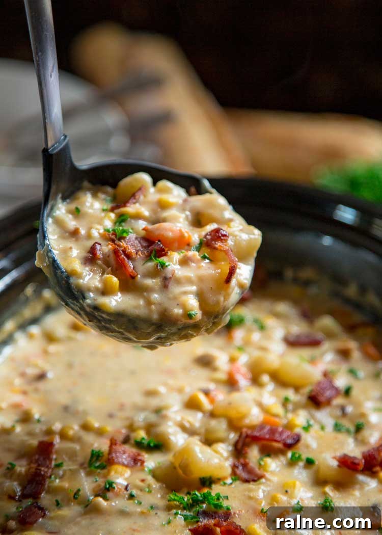 Creamy Slow Cooker Corn Chowder Recipe for Cozy Weeknights 5 ladle full of thick creamy soup with potatoes and bacon