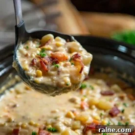 Creamy Slow Cooker Corn Chowder Recipe for Cozy Weeknights 7 close up: ladle full of crock pot corn chowder