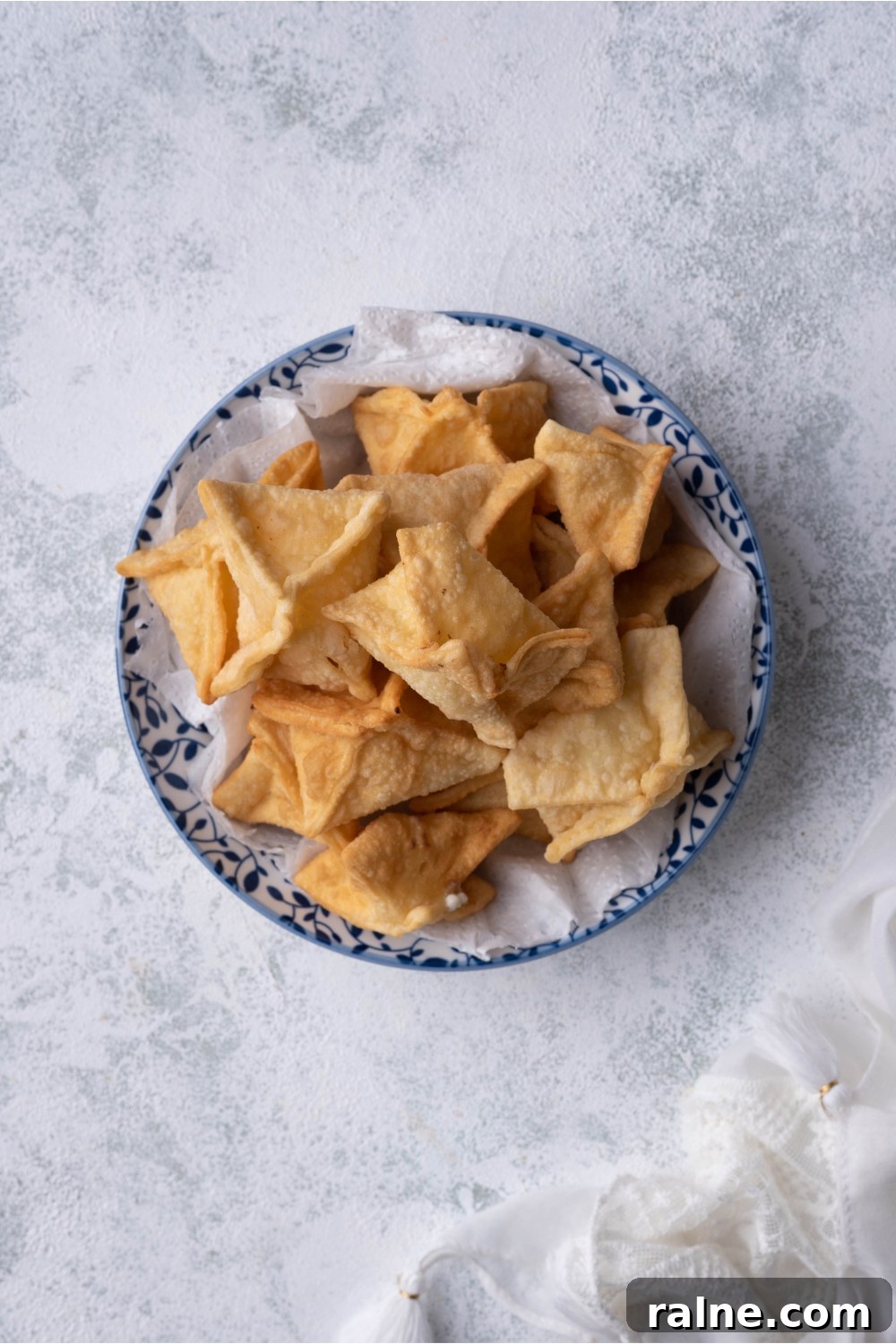 Crispy Cream Cheese Rangoon Wontons: Easy Homemade Recipe 9 A bowl filled with Panda Express cream cheese rangoon piled on top of each other.