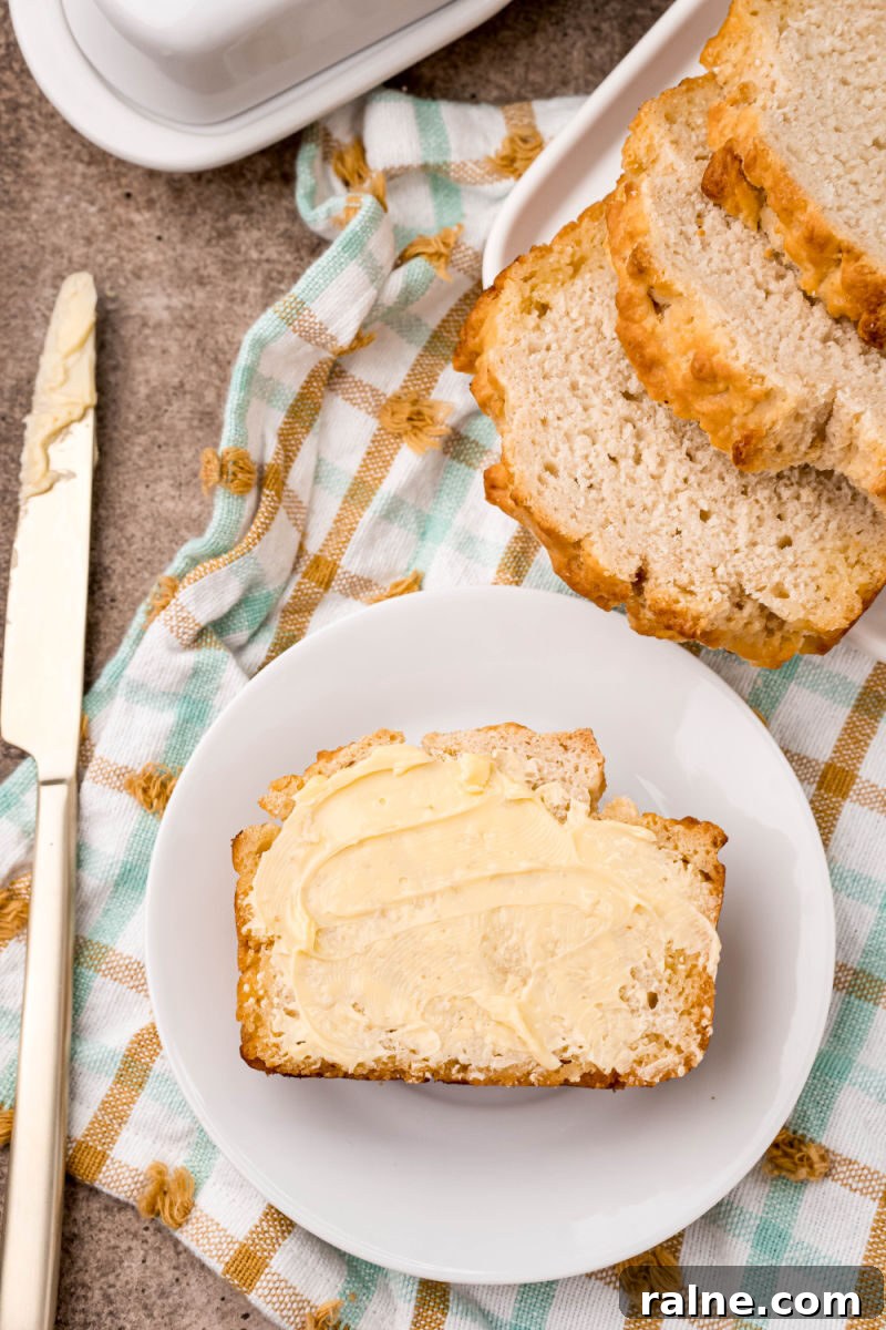 No-Fuss Beer Bread Recipe: Crispy Crust, Tender Inside 3 slice of beer bread with butter next to the loaf
