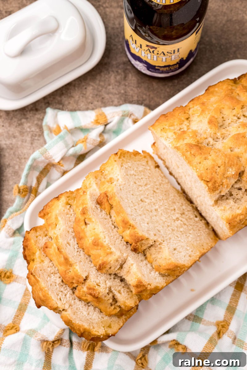 No-Fuss Beer Bread Recipe: Crispy Crust, Tender Inside 9 looking down at beer bread cut into slices on a platter