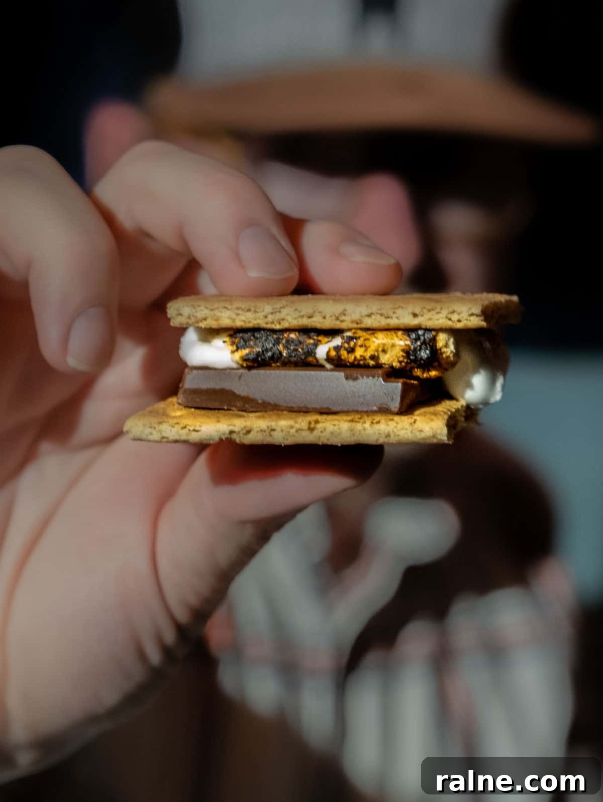 Solo Stove S'mores Bowl Review – Indoor S'mores Kit Guide 6 Sean Martin from Vindulge holding a s'more made with chocolate and roasted marshmallows