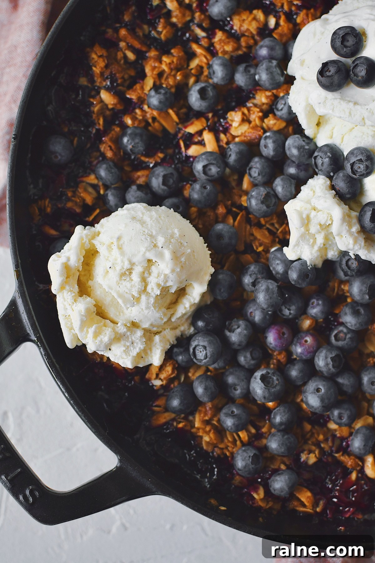 Crisp fresh from the oven with vanilla ice cream on top and extra blueberries.