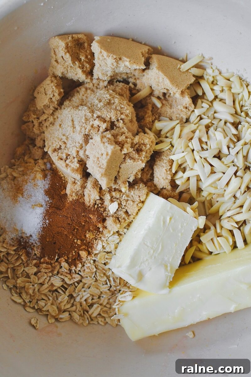 Butter, brown sugar, cinnamon, ginger, salt, and slivered almonds in a large bowl before mixing the crisp topping.