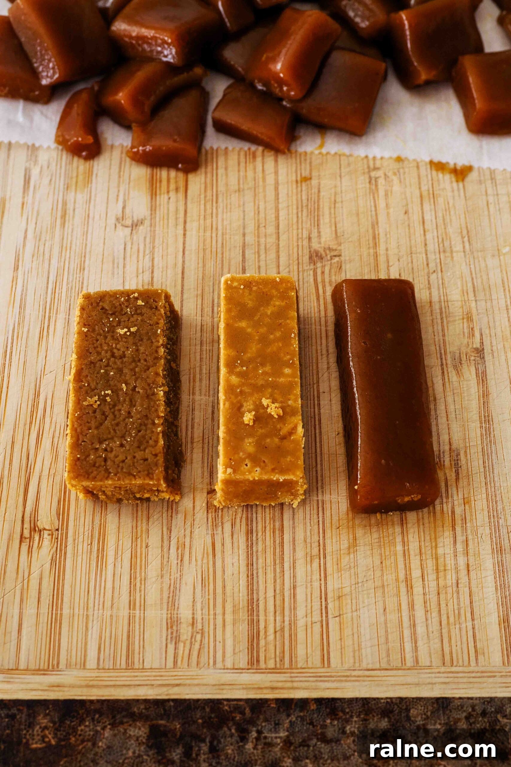 Pumpkin Spice Caramels Recipe: Homemade Fall Candy Guide 17 Three caramels on a cutting board: The two leftmost caramels are grainy and crystallized, and the caramel on the right is dark and shiny.