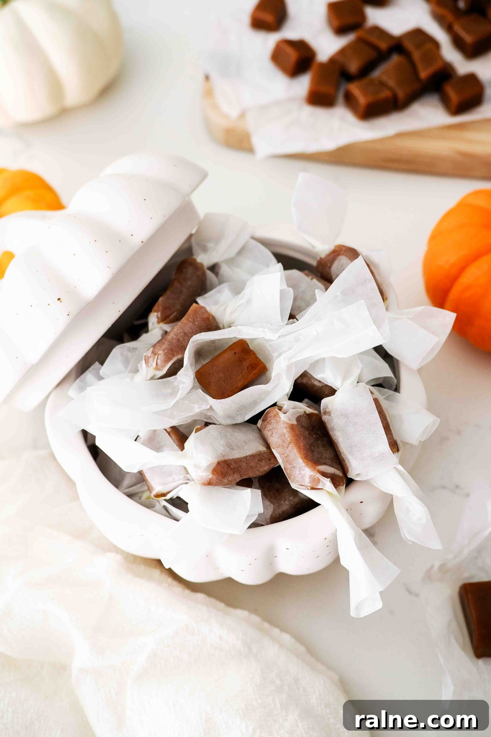 Pumpkin Spice Caramels Recipe: Homemade Fall Candy Guide 19 A stoneware pumpkin is filled with wrapped pumpkin spice caramels.
