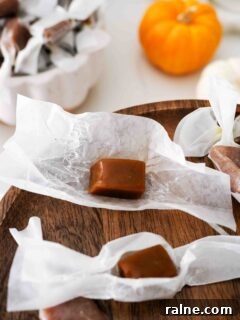 Pumpkin Spice Caramels Recipe: Homemade Fall Candy Guide 21 A pumpkin spice caramel rests on top of its wrapper with another nearby.