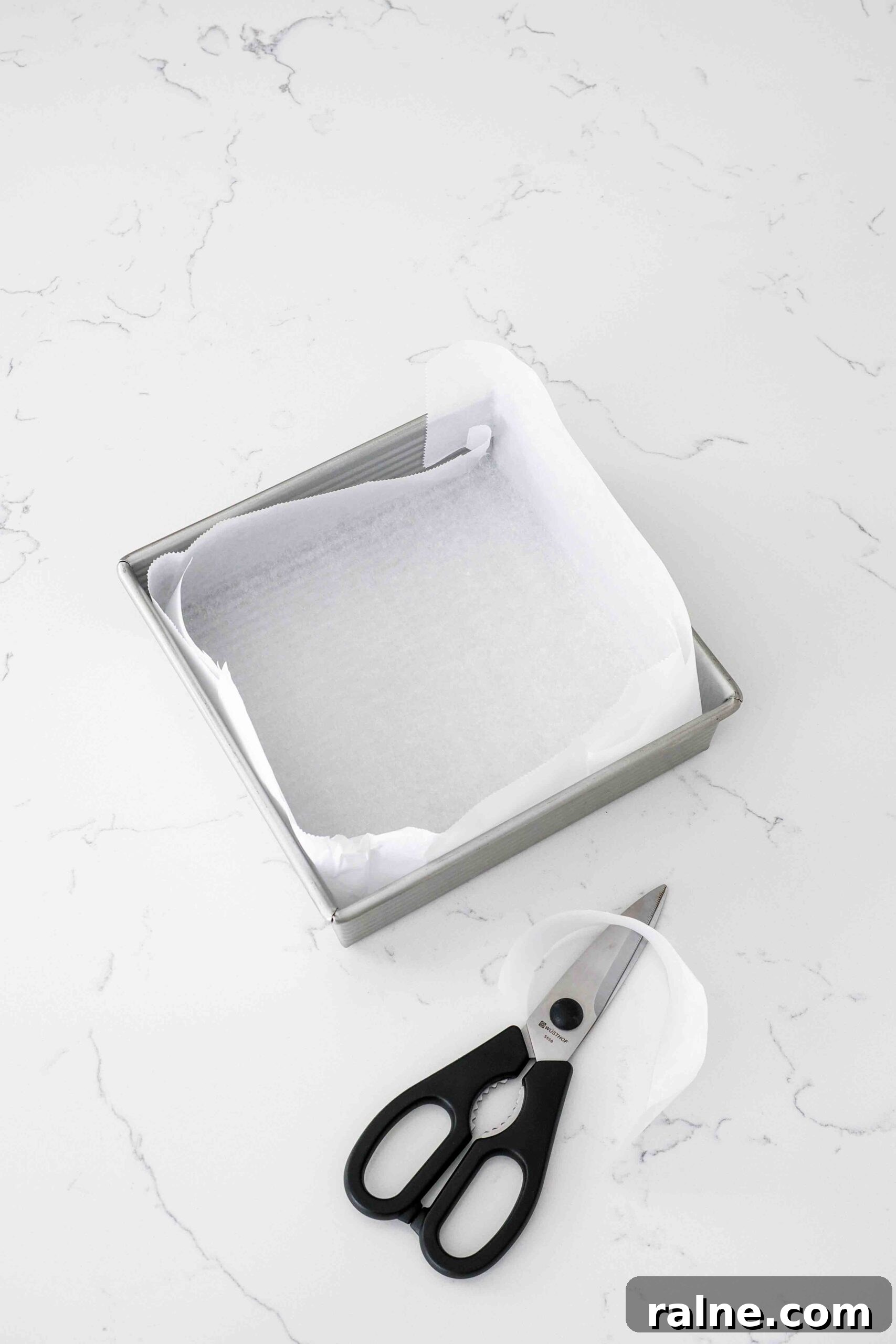 Pumpkin Spice Caramels Recipe: Homemade Fall Candy Guide 4 A square pan is lined with parchment paper.