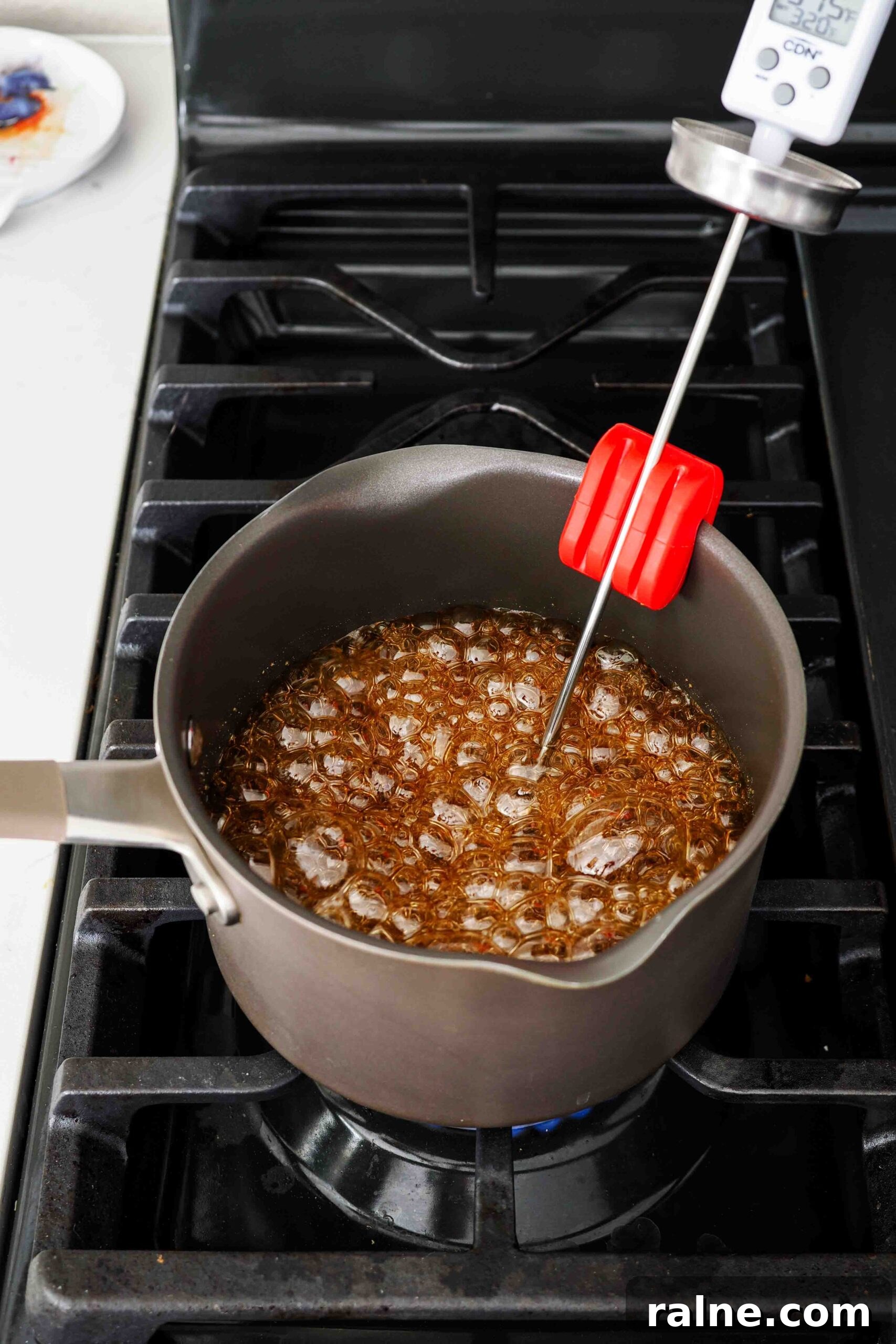 Pumpkin Spice Caramels Recipe: Homemade Fall Candy Guide 8 Caramel in a pot over the stove at 315°F.