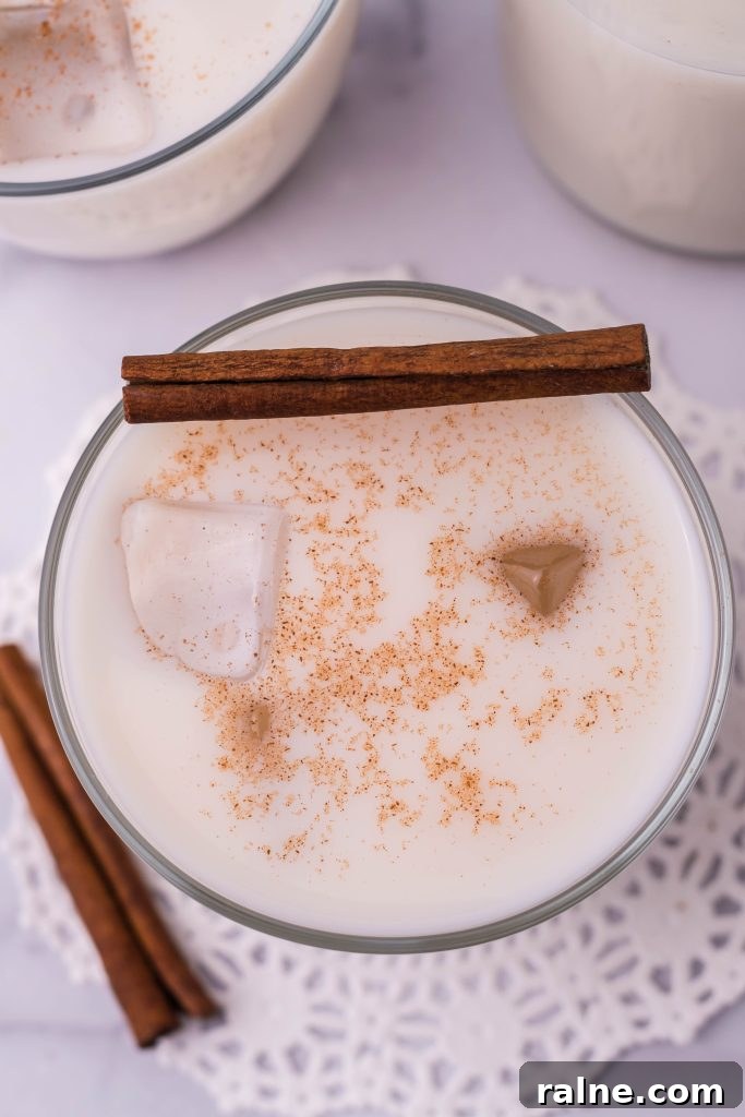 Authentic Horchata Recipe: How to Make Mexican Rice Horchata 3 traditional horchata served in a clear glass with ice and topped with a pinch of ground cinnamon for garnish