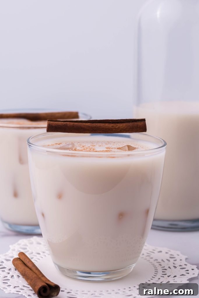 Authentic Horchata Recipe: How to Make Mexican Rice Horchata 4 traditional horchata served in a clear glass with ice and topped with a pinch of ground cinnamon for garnish