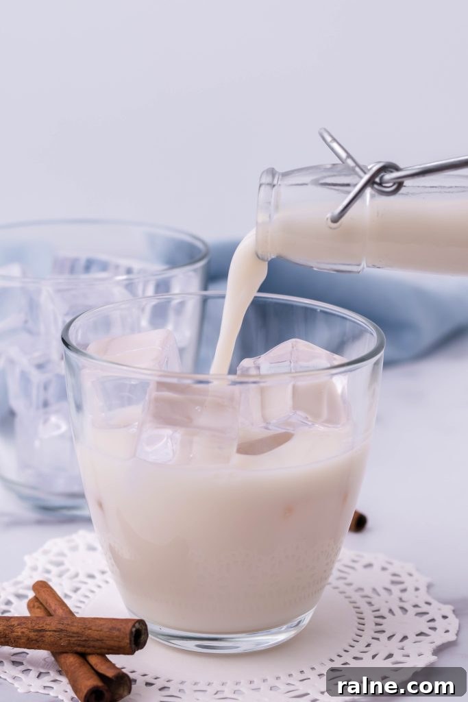 Authentic Horchata Recipe: How to Make Mexican Rice Horchata 5 authentic Mexican horchata being poured over ice in a clear glass