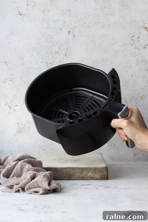 T17067 Tower Air Fryer Review: Real Results and Key Features 8 Someone showing the inside of a Tower air fryer drawer