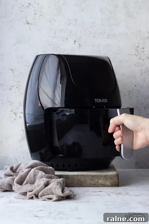 T17067 Tower Air Fryer Review: Real Results and Key Features 5 Someone pulling the drawer open on an air fryer