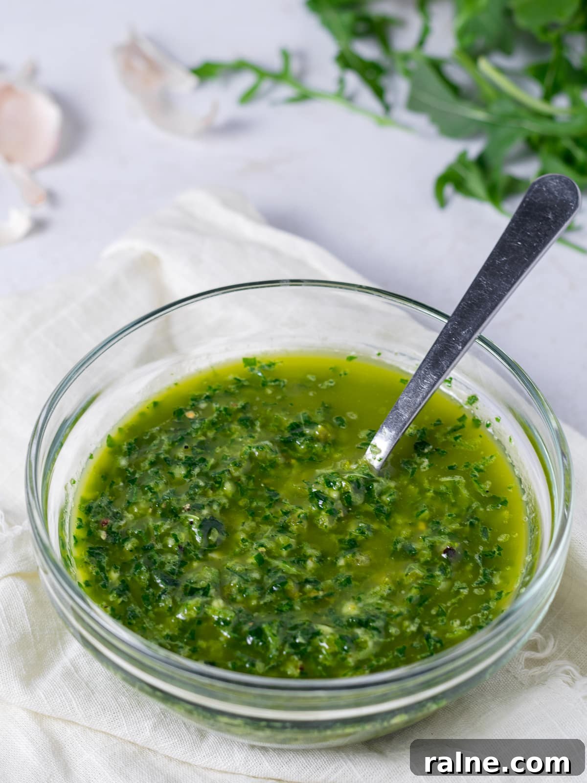 Arugula Chimichurri Sauce Recipe for Grilled Meats & Veggies 2 small glass bowl with flavorful green chimichurri