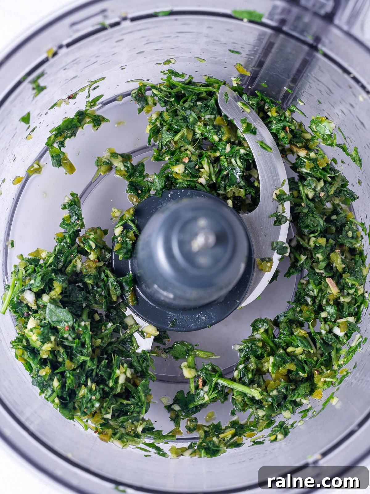 Arugula Chimichurri Sauce Recipe for Grilled Meats & Veggies 5 food processor bowl with the pulsed up ingredients