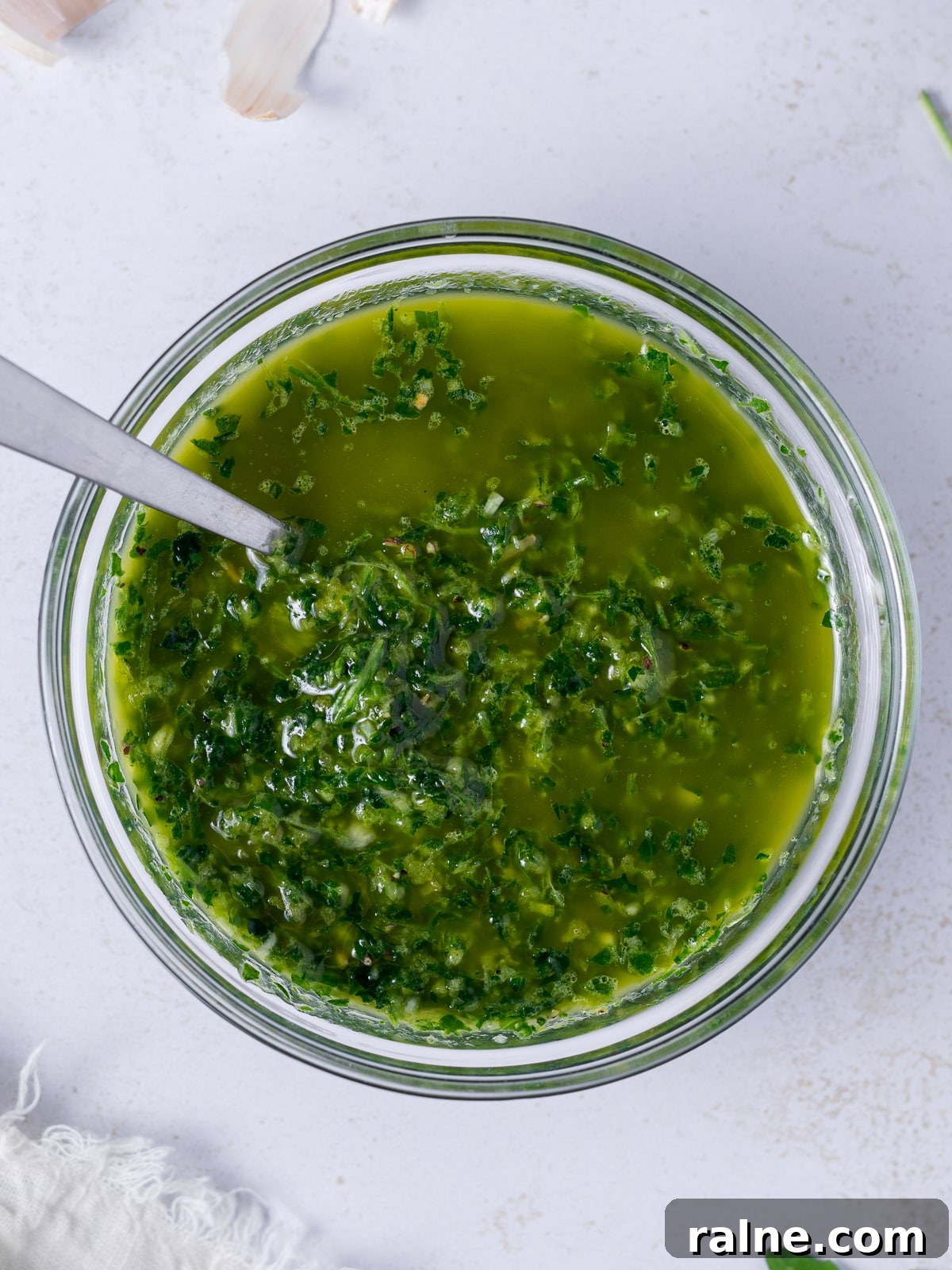 Arugula Chimichurri Sauce Recipe for Grilled Meats & Veggies 8 small bowl of arugula chimichurri with spoon in it