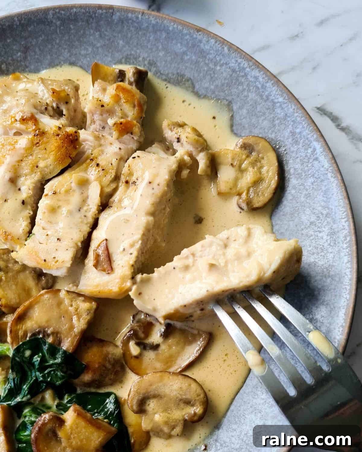 Close up of bite sized chicken breasts covered in creamy mushroom sauce