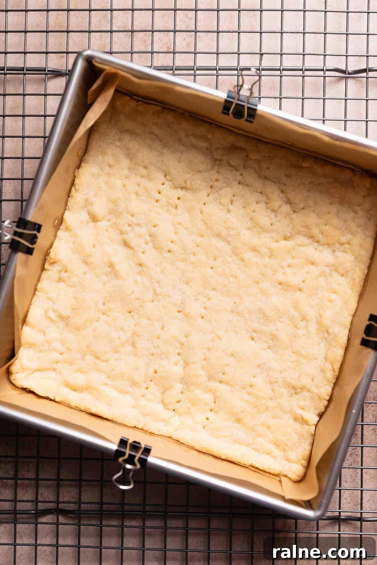 Classic Lemon Bars with Buttery Shortbread Crust 5 A pan with the baked shortbread crust cooling on a wire rack.