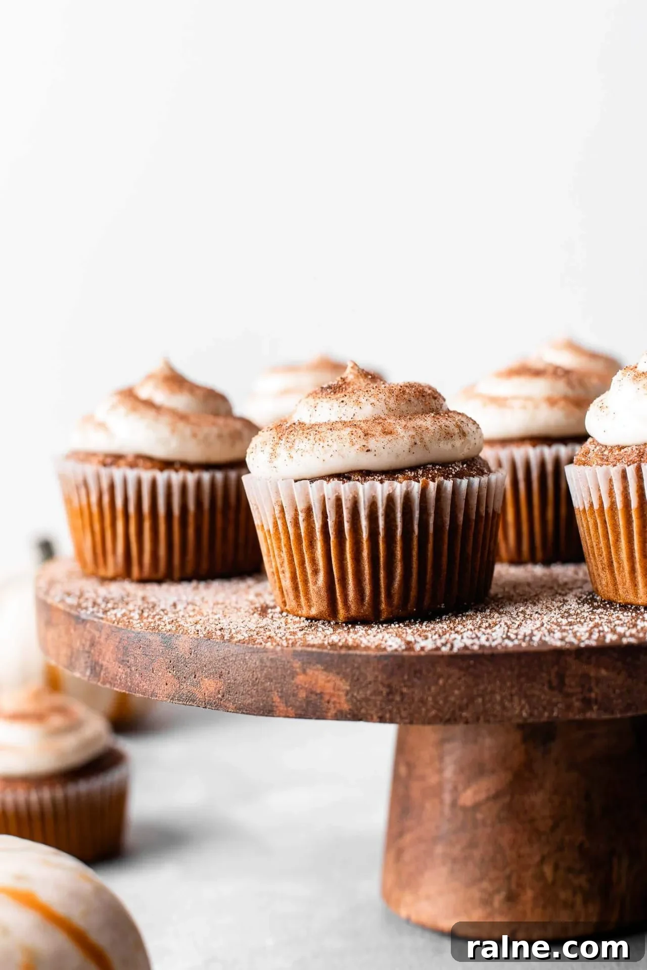 Pumpkin Spice Latte Cupcakes: Moist Espresso-Infused Fall Treats 11 frosted pumpkin spice latte cupcakes on wooden cake stand-2