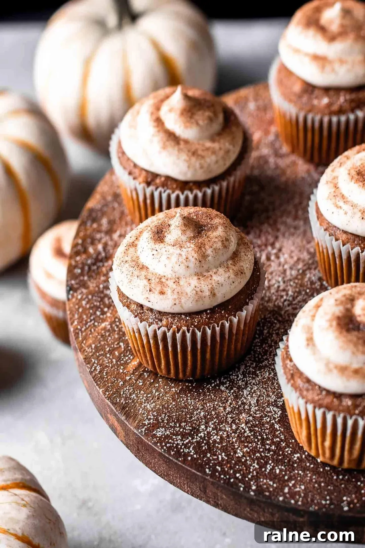 Pumpkin Spice Latte Cupcakes: Moist Espresso-Infused Fall Treats 14 frosted pumpkin spice latte cupcakes on wooden cake stand with pumpkin spice sugar sprinkled on top (3)