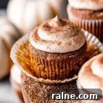 frosted pumpkin spice latte cupcakes on wooden cake stand with pumpkin spice sugar sprinkled on top (10)