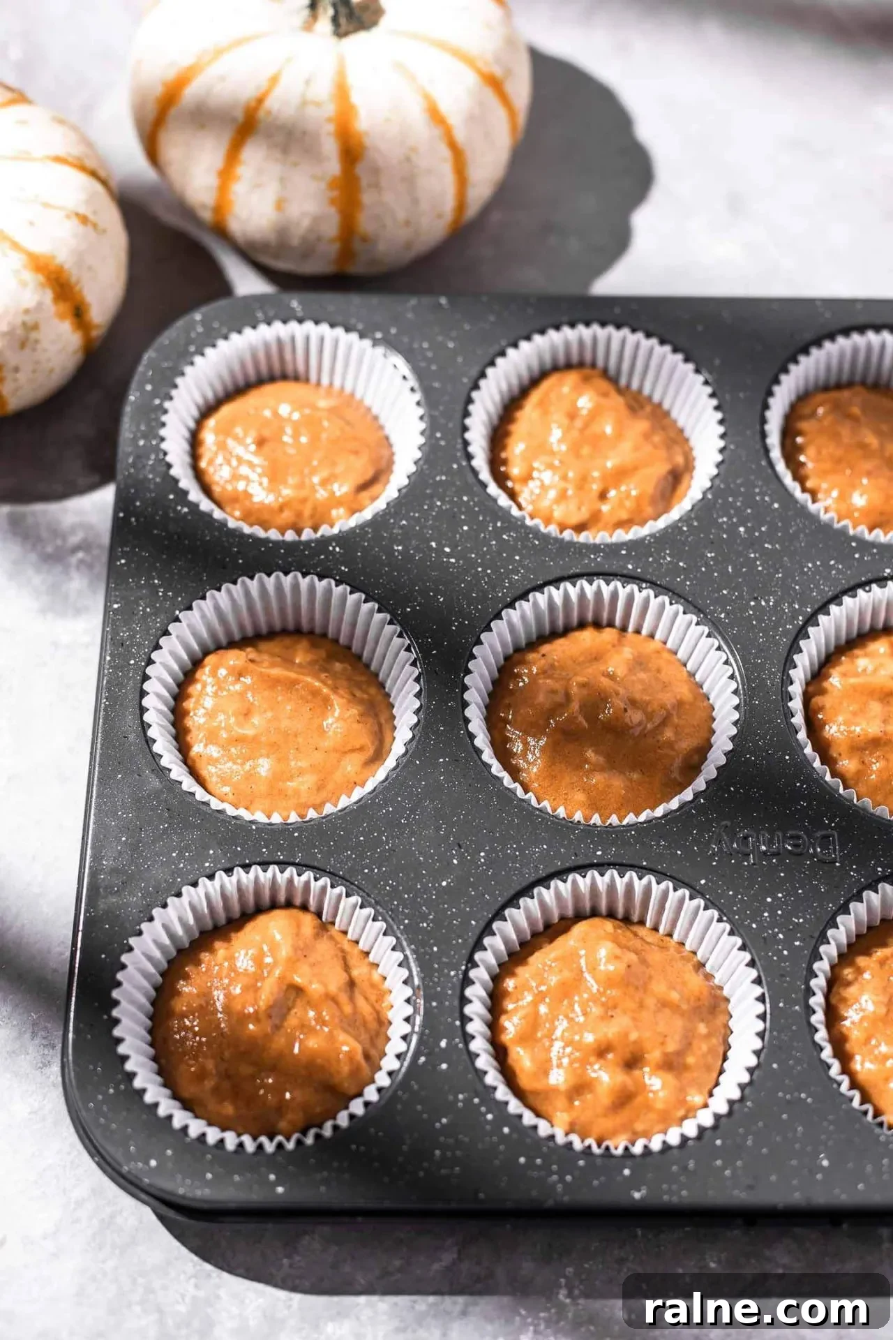 Pumpkin Spice Latte Cupcakes: Moist Espresso-Infused Fall Treats 8 pumpkin spice latte cupcake batter portioned into cupcake tin