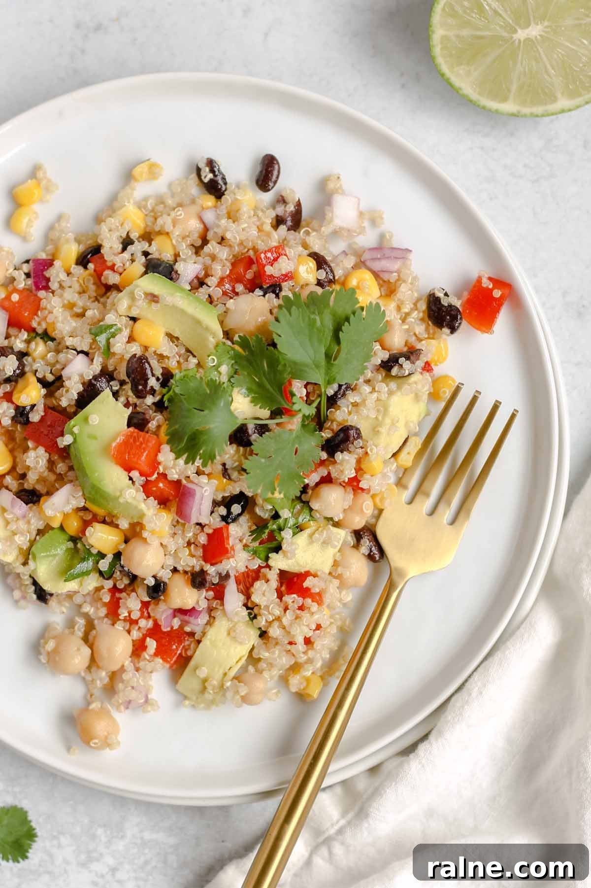 Southwest Quinoa Salad with Avocado and Zesty Lime Dressing 2 Single serving of southwest quinoa salad on a small white plate.