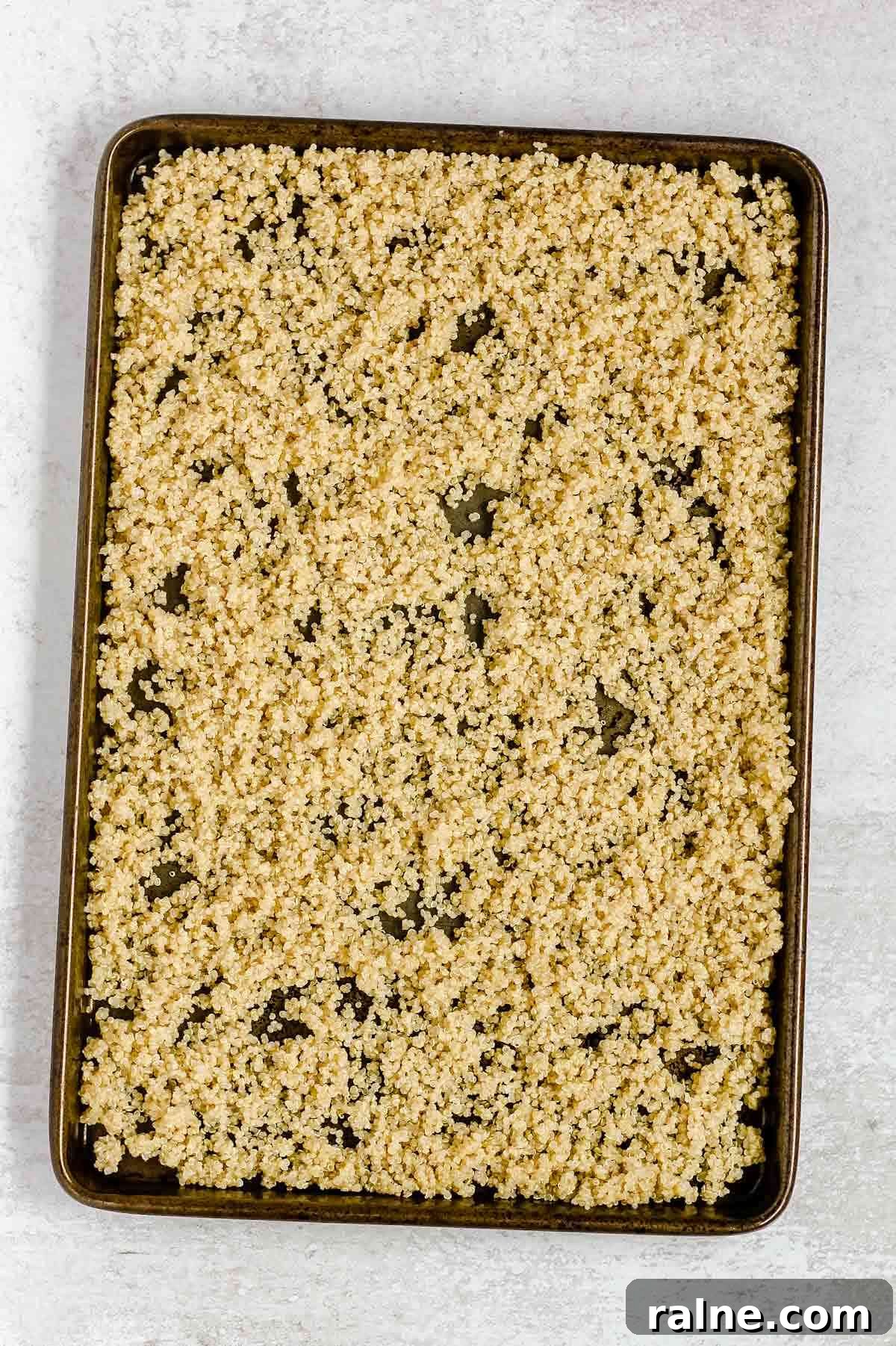 Southwest Quinoa Salad with Avocado and Zesty Lime Dressing 5 Cooked quinoa on a cookie sheet.