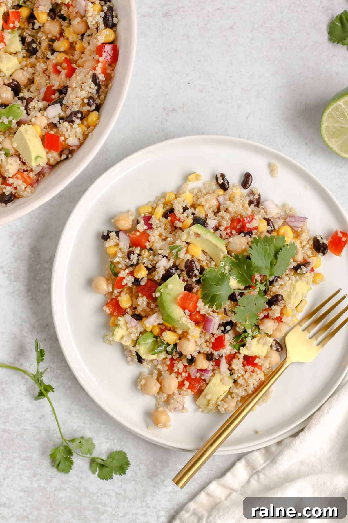 Southwest Quinoa Salad with Avocado and Zesty Lime Dressing 10 Single serving of southwest quinoa salad on a white plate with a gold fork.