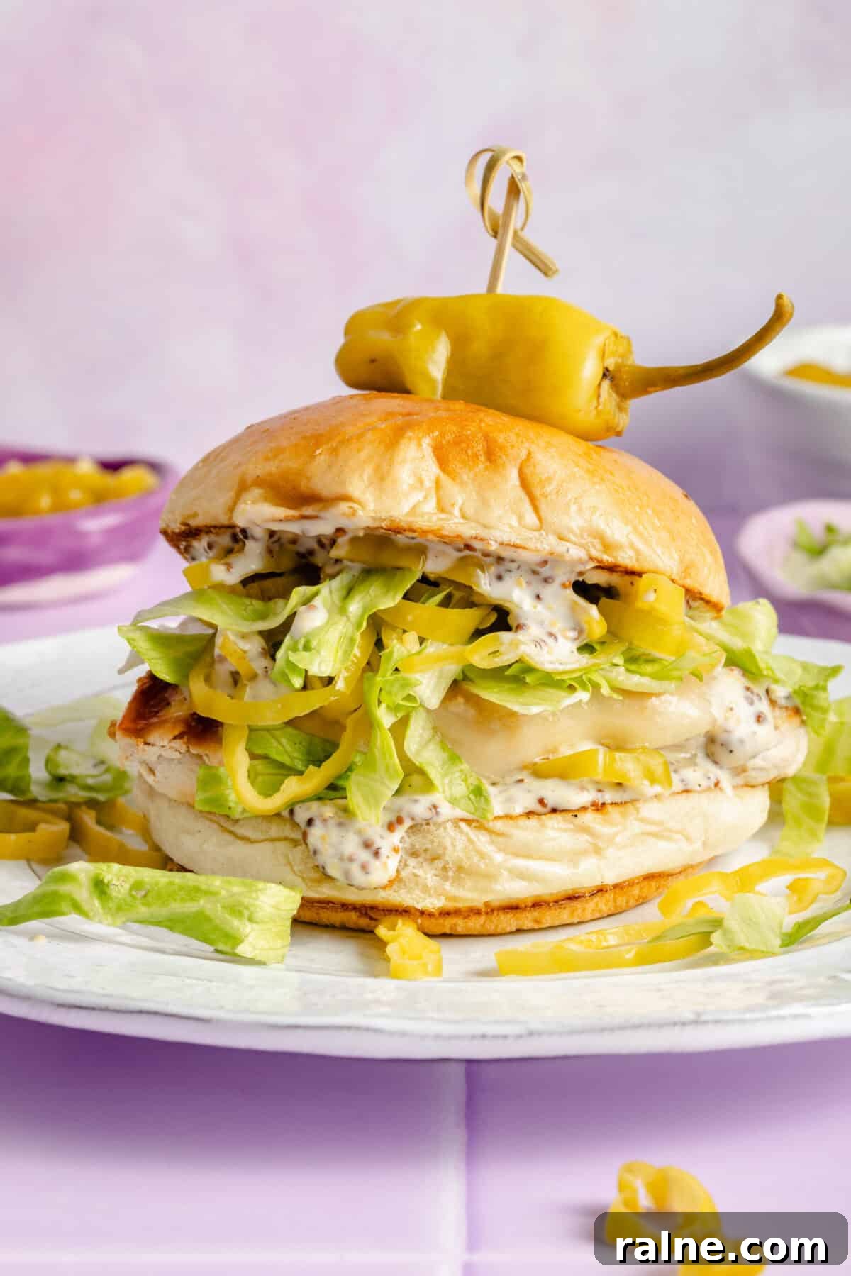 Grilled Chicken Sandwiches with Tangy Pepperoncini Sauce 2 Pepperoncini Grilled Chicken Sandwich on plate.