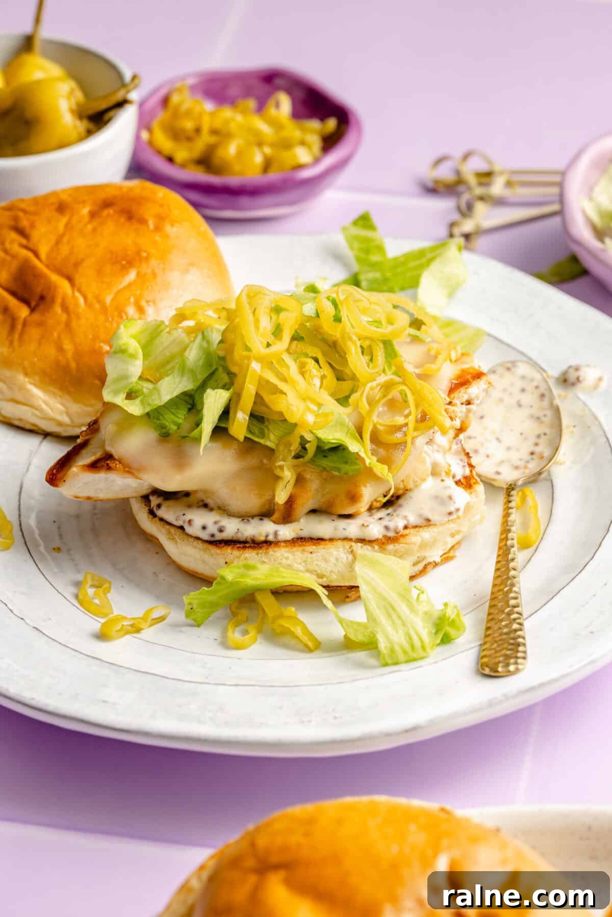 Grilled Chicken Sandwiches with Tangy Pepperoncini Sauce 5 Pepperoncini Grilled Chicken Sandwich assembled on plate.