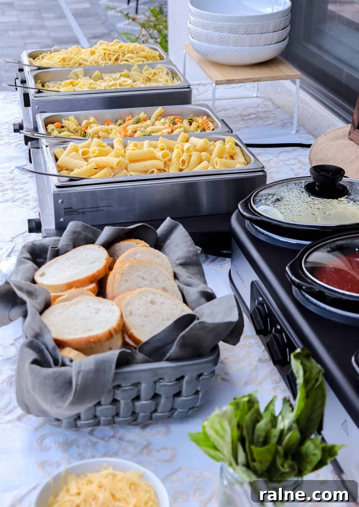 Party Pasta Bar Ideas: How to Set Up a Crowd-Pleasing Pasta Station 7 Pasta bar buffet table with pasta, bread and sauces.