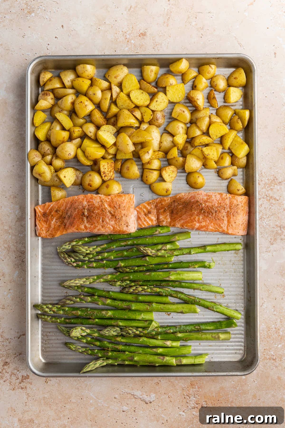 Salmon Asparagus and Potatoes on a sheet pan ready for the oven