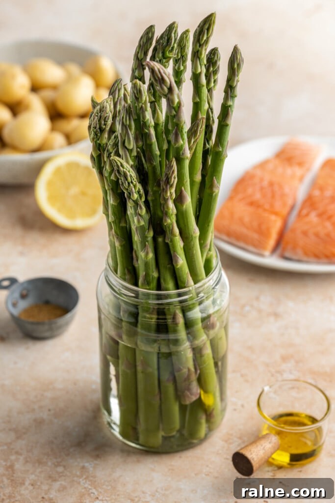 Storing asparagus before use in sheet pan salmon dinner.